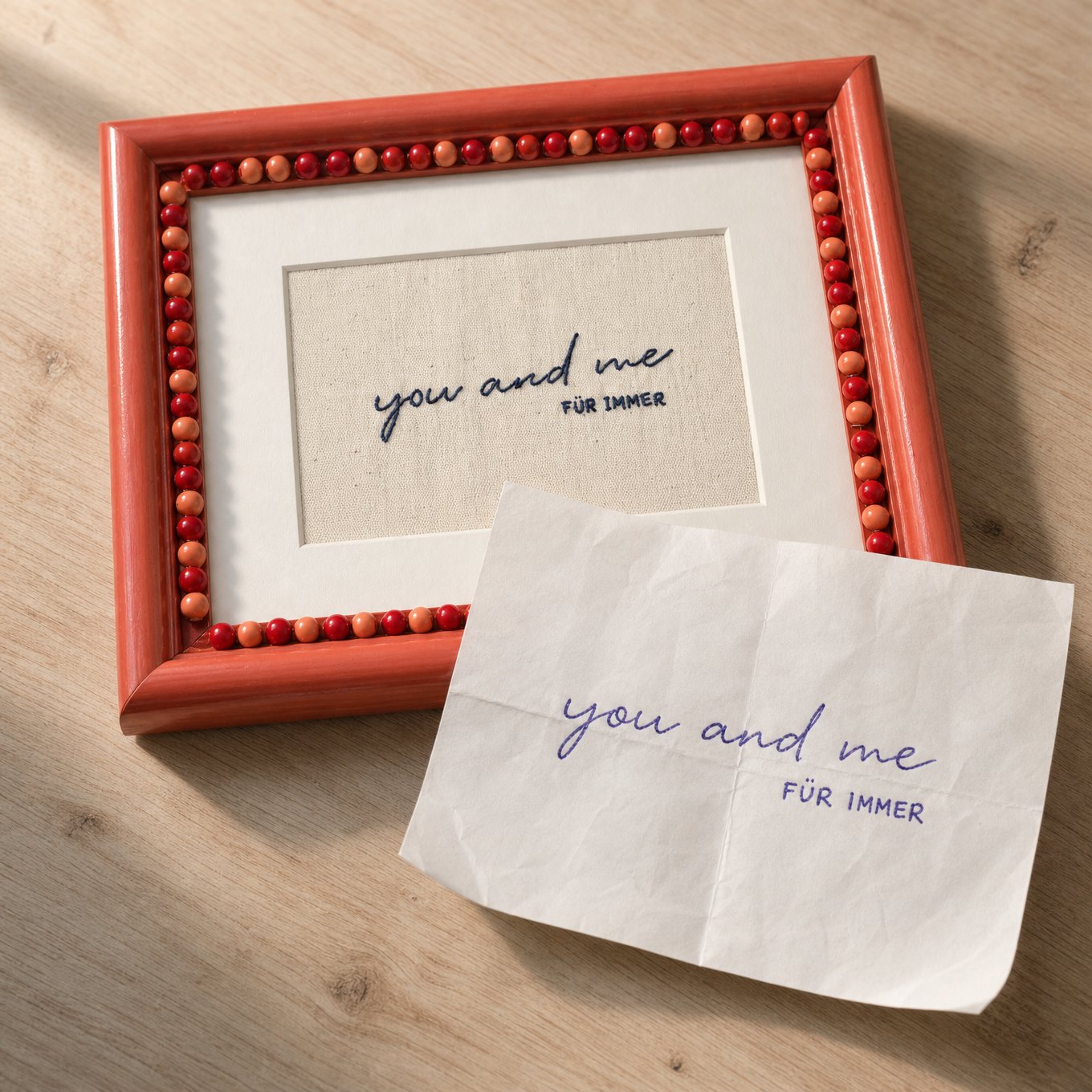 A handwritten note next to the finished embroidered keepsake it inspired, "you and me für immer"