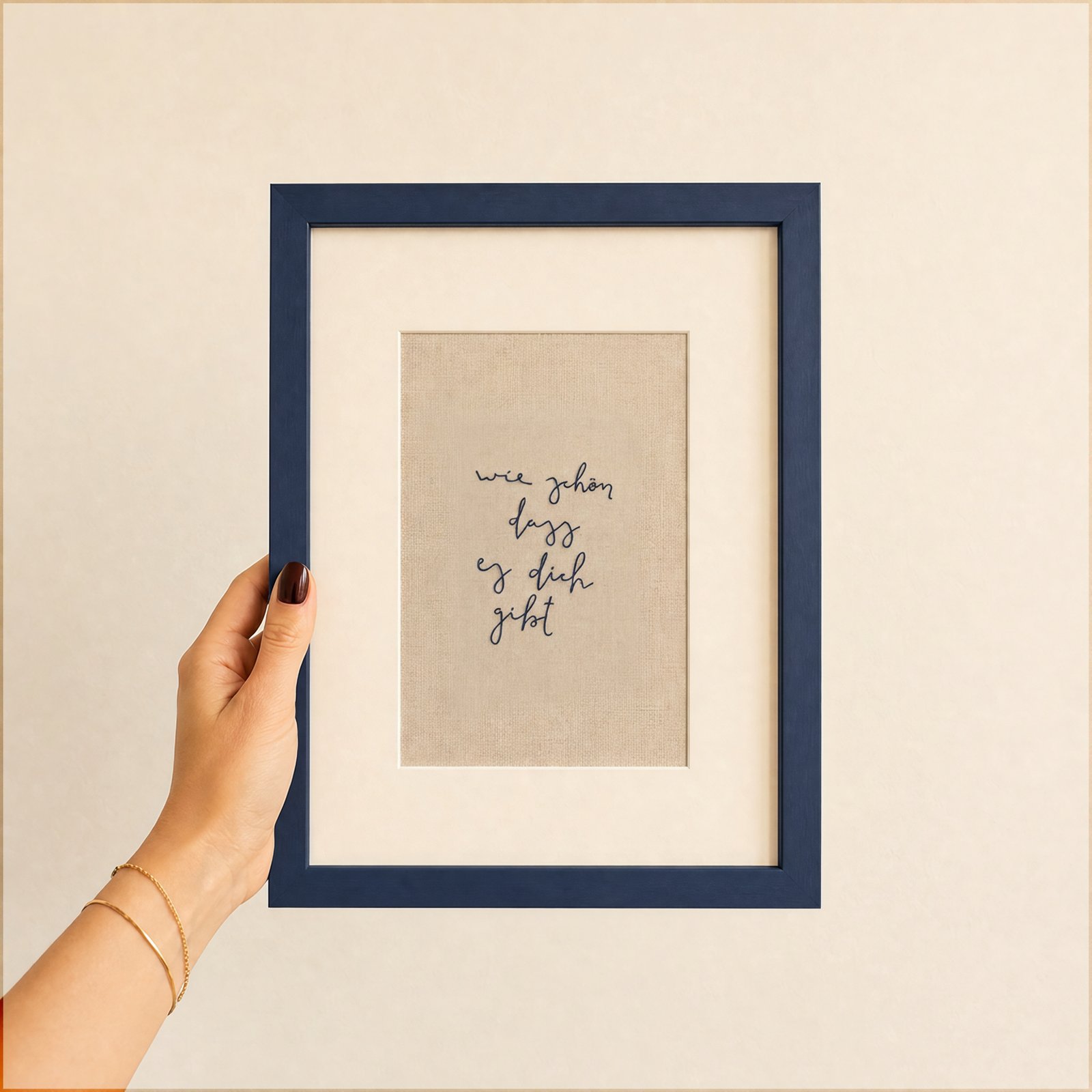 Framed embroidered piece reading "wie schön dass es dich gibt"